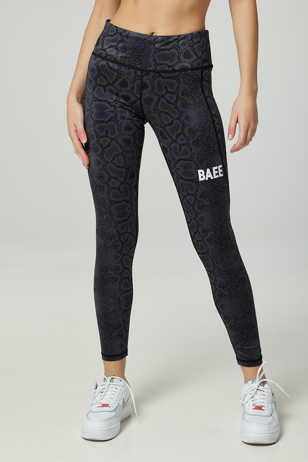 BAEE logo on leg of black gym leggings