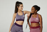 Models wearing seamless womens sports bras in burgundy and purple